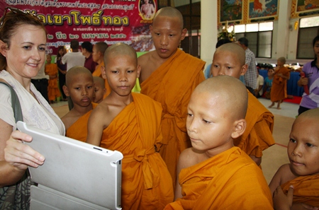 The new monks were happy looking at photos of themselves.