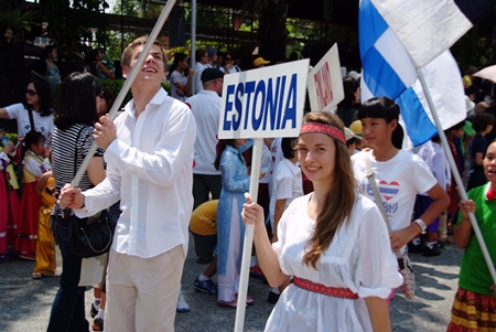 Signs and flags are held high in the parade of nations.
