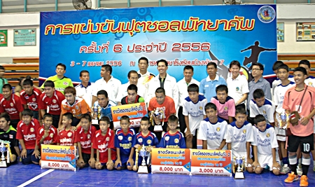 Winning teams show off their trophies as they pose with dignitaries and officials at the conclusion of the tournament.
