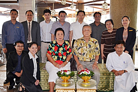Somchai Ratanaopath (rear 4th left), Chairman of the Board, and Somkiet Ratanaopath (rear 4th right) standing), Managing Director of the A-One The Royal Cruise Hotel Pattaya gathered together his management and staff to pay their respects to Mitr Ratanaopath and Wantana Ratanaopath (seated) founders and owners of the hotel.