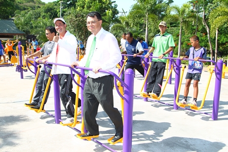 Mitsubishi Electric Kanyong Wattana Co. Managing Director Anant Banjerdthum, along with Mayor Itthiphol Kunplome, local officials and guests try out the new exercise equipment.