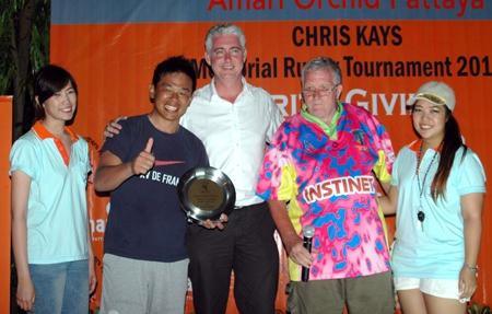 A smiling skipper from the Bangkok Japanese (2nd left) collects the tournament Plate.