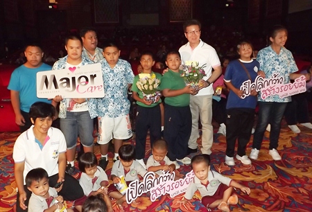 Thanakorn Pulilaekin (center, white shirt), film administrator for Major Cineplex Group, unveiled the Major Care Foundation initiative May 23 at The Avenue galleria theater.