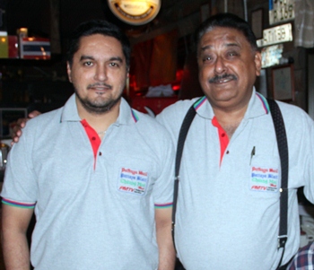 Son Prince Malhotra (left) poses for a photo with his proud father Peter.