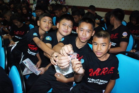 Children from Pattaya School No. 1 proudly show off their D.A.R.E brooches.
