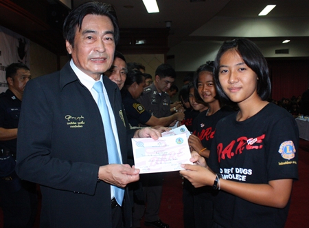 Deputy Mayor Ronakit Ekasingh (left) presents certificates to students who completed the D.A.R.E project.