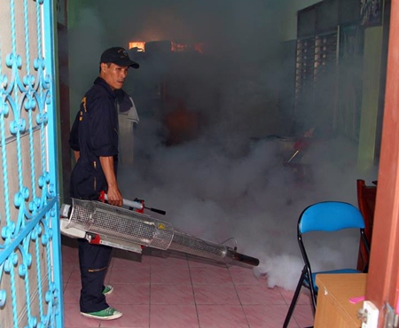 City workers go house to house in North Pattaya, spraying insecticides to kill mosquitoes.