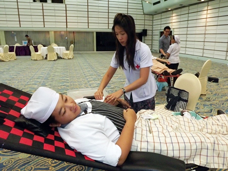 A nurse extracts blood from one of many Asia Hotel employees who took the time to donate earlier this month.