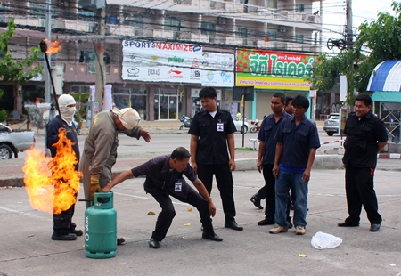 Residents and staff learn how to shut off a flaming gas tank.