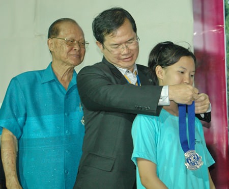 Father Picharn Jaiseri presents the president’s sash to new president Lalita Phetphuang.