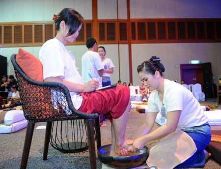 Participants in the Thai Massage Competition massage the judging committee.