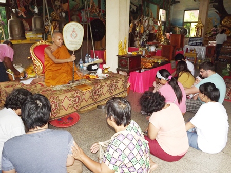 Buddhists listen to sermons and make merit at Wat Suttawas in Nongprue.