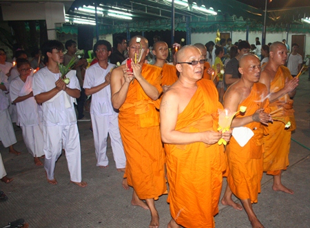 Monks perform the Wien Thien ceremony at Wat Khao Phra Yai, leading Buddhists on Asalaha Bucha Day.