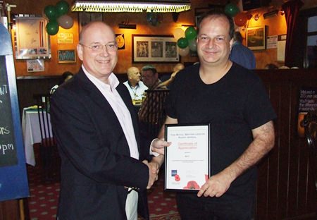 Graham Macdonald (left) presents a certificate of appreciation to Greg Watkins from the British Chamber of Commerce Thailand, who sponsored the first Gurkha Curry Night.