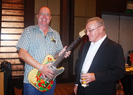 (L to R) Richard Kings holding his new replica of Jimmy Page’s Dragon Telecaster guitar alongside him is Niven Walters who crafted and donated it.