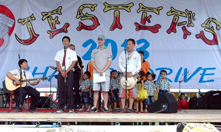 Representatives from The Regent’s International School sing the national anthem before opening Jesters Care for Kids 2013 Charity Fair.
