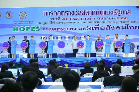 Local government officials take to the stage with the lovely ball girls to inspect the Government Lottery Office’s Sept. 1 drawing in Pattaya.