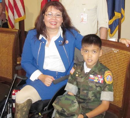 U.S. Congresswoman Tammy Duckworth and Young Marines L/Cpl Bret Mays.