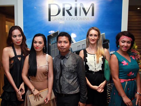 Porchland Group CEO, Chisanucha Phakdeesaneha (center), poses with guests at the launch of the Prim Grand Condominium on Oct. 8. 