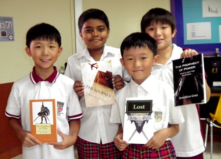 Year 4 and Year 6 students stand proudly with their published novels (2012).