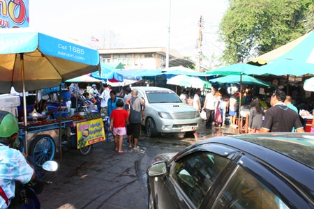 Vendors have set up their wares on the sidewalks leading to the parking lot in the Lan Po Market area.