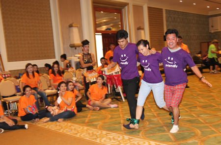 The Friendly purple team races across the finish line in the 3-legged race.