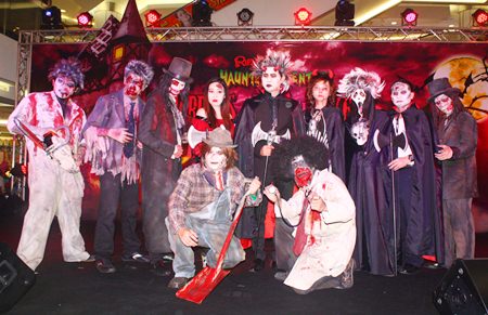 Somporn Naksuetrong (center), vice president of the Royal Garden Plaza, brings out the ghosts, ghouls and goblins to begin the Halloween Fancy Costume Contest.