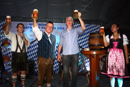 Their beer krugs charged to the brim, Brendan, Ken and Panpicha cry “Prost”.