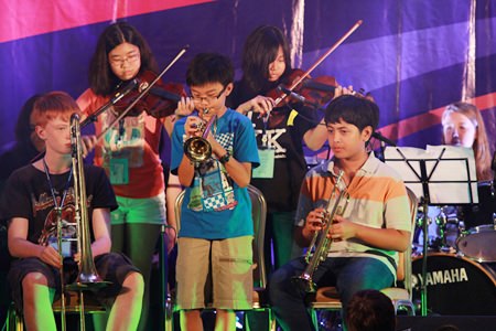 Young stars play trumpets and violins during the FOBISSEA Music Festival.
