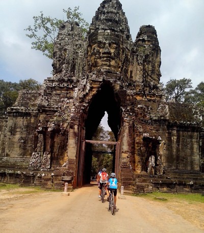 Poppy and her support team peddling through the gates to Angkor Wat.