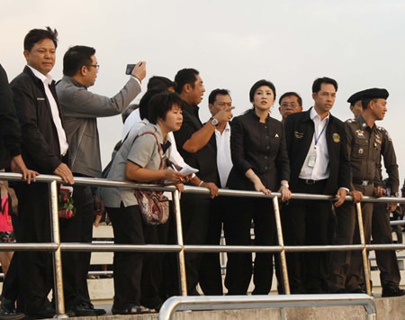 The look of concern shows on Prime Minister Yingluck Shinawatra (Front row 3rd right) as officials explain what happened when an overcrowded ferry operated by Koh Larn Travel and being captained by a man who confessed to being high on methamphetamines capsized, killing six tourists; 3 Thais, 2 Polish and 1 Hong Kong Chinese.  