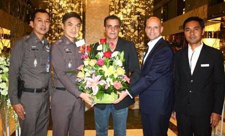 Pattaya Police Superintendent Pol. Col. Suwan Cheaonawinthawat (2nd from left) presents a celebration bouquet to Tulip Group CEO Kobi Elbaz (center) and Centara Grand Pratamnak Resort Pattaya GM Dominique Ronge (2nd from right).