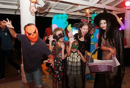 Maria Gequillana, PR and Marcom Manager of Royal Cliff Hotels Group with charming masked visitors at the “Monsters at the Cliff” Halloween Family Fun.