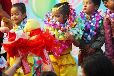 Parents present gifts to their children after their children’s stage performance on Children’s Day at Wat Chaimongkol Children’s Development Center.