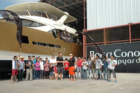 A job well done: Bernard Lamprecht and Philippe Guenat congratulate each other and the hard working staff as the Heliotrope is rolled out of the shipyard.