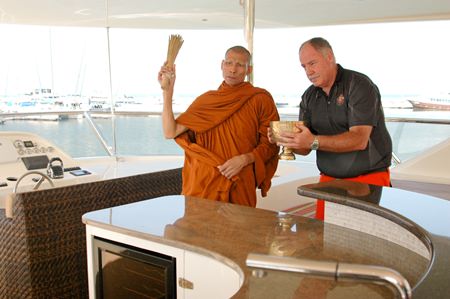 A revered Buddhist monk sprinkles lustral water on the Heliotrope calling on all that is holy to bless and safeguard her.