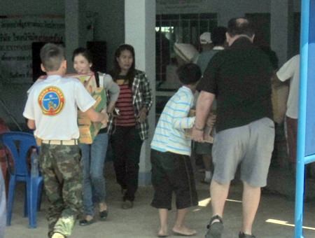 Young Marines L/Cpl Bret Mays, left, and VFW Post Commander Eric Larsen, being assisted by a student, unload the donations at the Ban Kru Boonchoo Home.