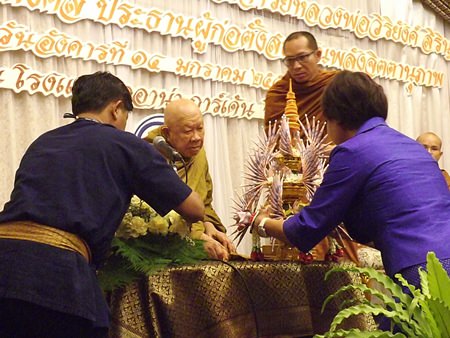 Sopin Thappajug presents a “phum ngern” silver cone containing funds raised for the new Willpower Institute to Luang Pho Viriyang Sirintharo.