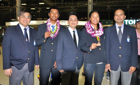 SEA Games Laser silver medalist Keerati Bualong (2nd left) and bronze winner  Kamolwan Chanyim (2nd right) are welcomed home by YRAT officials. (Photo/Saranya Ngarmdee)
