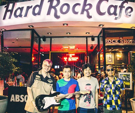 (From left): Mathew Carley, Hard Rock Cafe manager, is presented with the signed guitar from Thanachai Ujjin (Pod Modern Dog), May-T Noijinda and Pavin Suwannacheep.