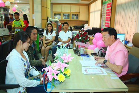 Banglamung District Chief Sakchai Taengho (right), giving thoughtful advice to couples getting married on Valentine’s Day.