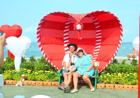A Russian couple poses for a commemorative Valentine’s photo at Pattaya Beach.