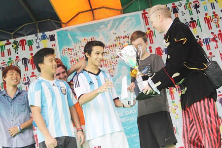 Principal Mike Walton hands over the Football World Cup Trophy to Team Argentina.