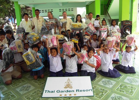 Children cheer the Thai Garden group for the great gifts they received.