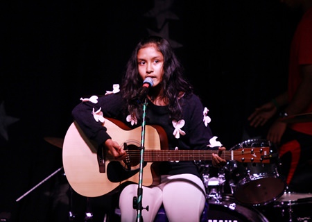 A Year 9 guitarist performs.