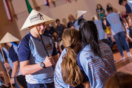 Students preparing for their final show, wearing traditional Vietnamese hats.
