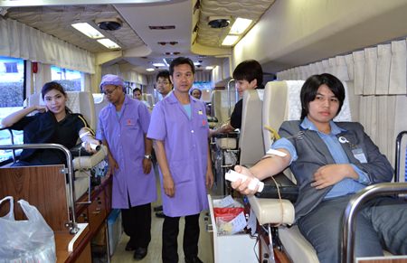 Employees at Pattaya’s King Power duty-free mall donate blood inside Queen Savang Vadhana Memorial Hospital’s 10-bed medically equipped bus.