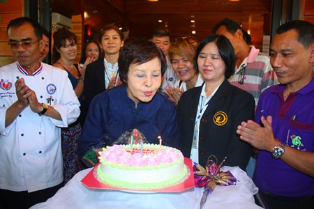 Sopin is cheered on by party guests as she blows out her birthday candles.