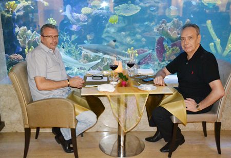 (L to R) Charly Geser and Peter Windgasse enjoy their wine at a great spot next to the aquarium inside the Oceana Lounge.
