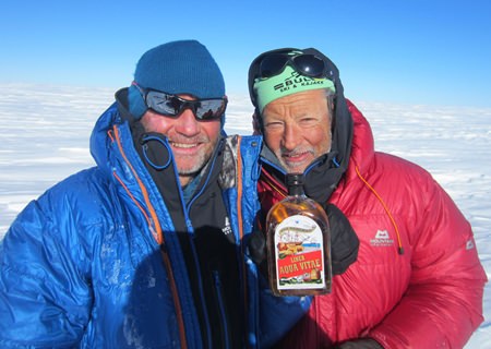 Totto Befring, Bangkok, and Nils Lie, Oslo, Norway, hold up the bottle of Liner Aqua Vitae during their cross-country ski across Greenland. (Photo: Jon Birger Skjaerseth, Oslo, Norway)